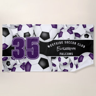 Lots of soccer balls purple black team colors beach towel