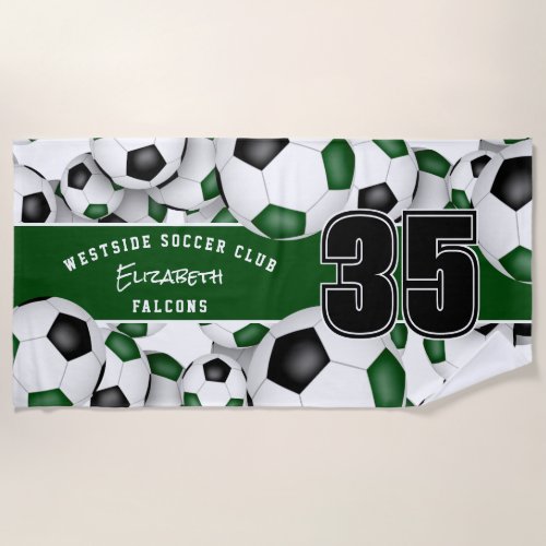 Lots of soccer balls with green black team colors beach towel