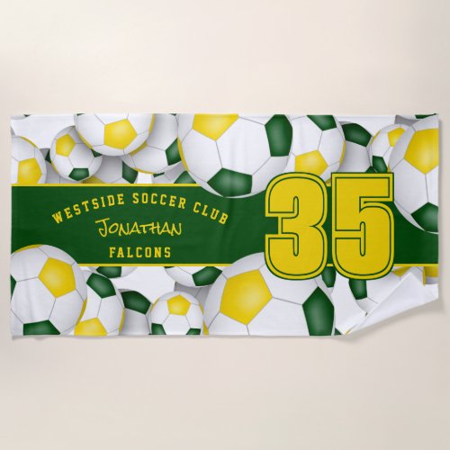 Lots of soccer balls with green gold team colors beach towel