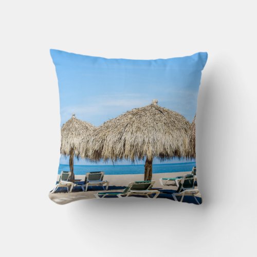 Lounge Chairs And Thatch Umbrellas On Beach Throw Pillow