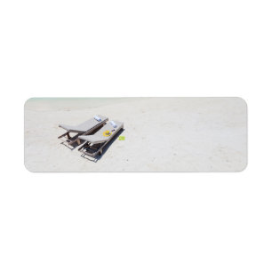 Lounge chairs on a beach label