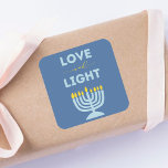 "Love and Light" Jewish Menorah Blue Hanukkah Square Sticker<br><div class="desc">Featuring a serene blue background,  a bright menorah illustration,  and the inspiring message "Love and Light, " these stickers add warmth and meaning to your holiday gatherings. Perfect for family dinners,  parties,  or any festive Hanukkah occasion,  they bring both style and spirit to the celebration.</div>