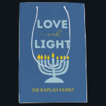 "Love and Light" Menorah Personalized Hanukkah Medium Gift Bag<br><div class="desc">Elevate your Hanukkah gift-giving with this festive "Love and Light" gift bag. Featuring a menorah design, a vibrant blue background, and customizable family text, this bag adds a personal and stylish touch to your holiday presents. Perfect for hosting Hanukkah parties, gifting friends and family, or wrapping up thoughtful keepsakes, this...</div>