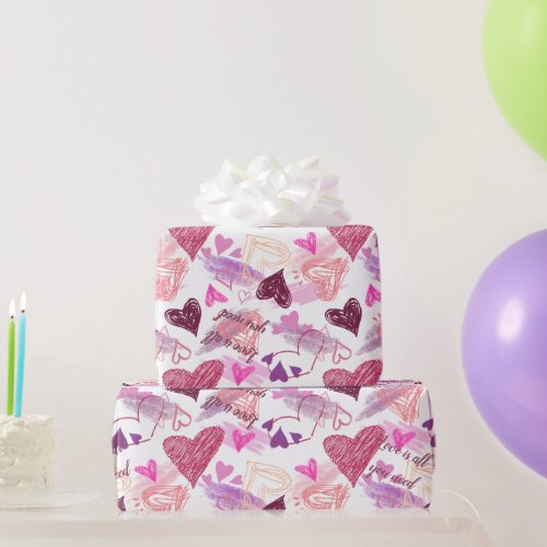 Love is all you need quote with pink hearts wrapping paper