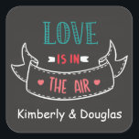Love Is In The Air Black Chalkboard Personalized Square Sticker<br><div class="desc">Love is in the air! These adorable sticker / seals features a vintage black chalkboard background highlighting the quote "Love is in the air" with a cute hand-drawn banner. Stickers can be personalized with the names of the bride and groom, or a family or even a business name. . Love...</div>