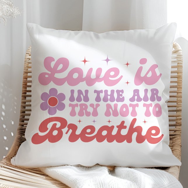 Love is in the Air Funny Anti Valentine  Throw Pillow (Love is in the Air Funny Anti Valentine Throw Pillow on a sunny rattan chair.)