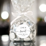 Love Is Sweet Wedding Favor Classic Round Sticker<br><div class="desc">Chic white sticker for your wedding reception dessert and candy favors featuring "Love Is Sweet" in simple modern typography and an elegant script with swashes,  your first names joined together by a heart and your wedding date.</div>