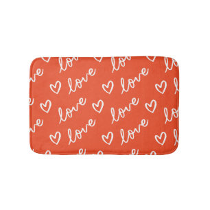 Love lettering & hearts drawing in red background bath mat