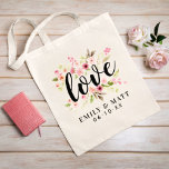 Love Pink Watercolor Flowers Wedding Monogram Tote Bag<br><div class="desc">Personalized tote bag design features the word "Love" in a black hand-lettered script typestyle, framed by a beautiful watercolor painted floral design of pastel pink, blush, and peach spring dahlia and rose flowers and green leaves. Also included is a modern and elegant monogram of the bride & groom names and...</div>