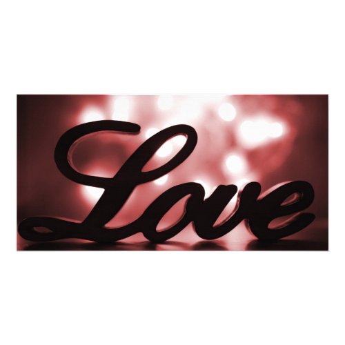Love sign with red sparkle lights behind card