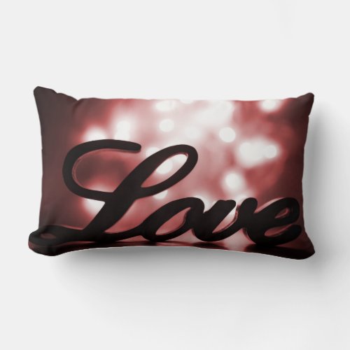 Love sign with red sparkle lights behind lumbar pillow
