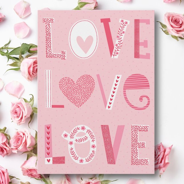 Love text in pink shades with hearts and flowers holiday card (Creator Uploaded)