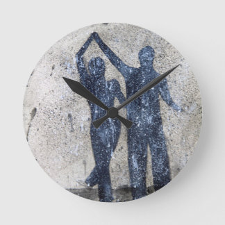 Lovers dancing in rain round clock