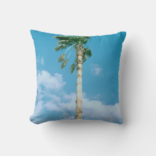 Low-angle photo of palm trees under blue sky throw pillow