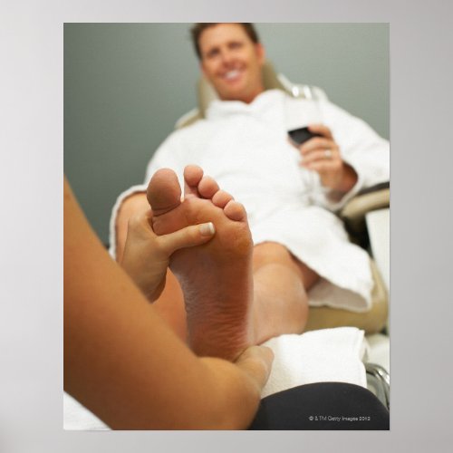 Low angle view of man receiving foot massage poster