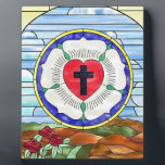 Luther Rose Stained Glass Window Plaque<br><div class="desc">The Luther Rose's symbolism dates back to the 1520s. Luther explained that the red heart with the black cross represents the righteous living by faith in Christ the Crucified. The heart rests on a white rose, symbolizing joy, comfort, and peace found through faith. The choice of white reflects the color...</div>