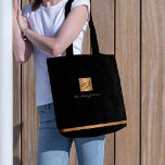 Luxury elegant gold modern black monogrammed tote bag<br><div class="desc">Classy exclusive looking office or personal monogrammed tote bag featuring a faux copper metallic gold glitter square with your monogram name initials and a sparkling stripe over a stylish black faux leather look background. Suitable for small business, corporate or independent business professionals, personal branding or stylists specialists, makeup artists or...</div>