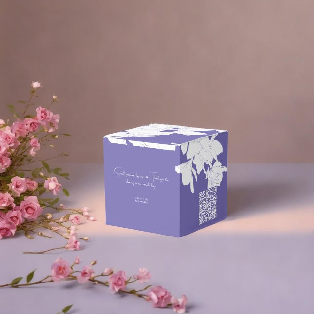 Luxury purple flowry  favor boxes (a purple floral favor box with a white flowers placed on soft surface surrounded with pnik flowers)