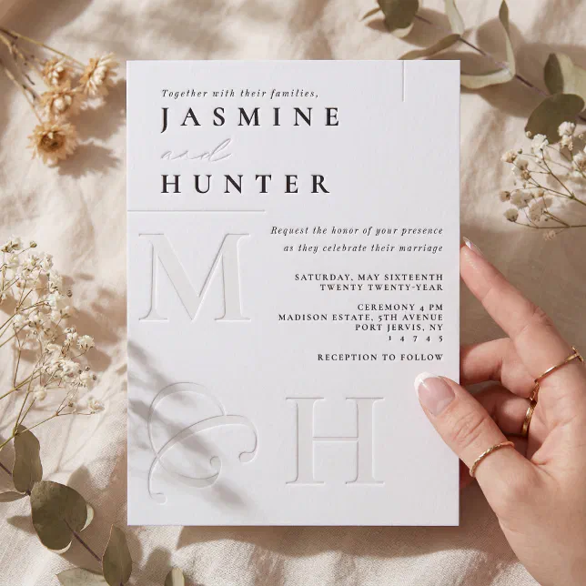 A luxurious but simple letterpress invitation with lots of typography and debossed details.