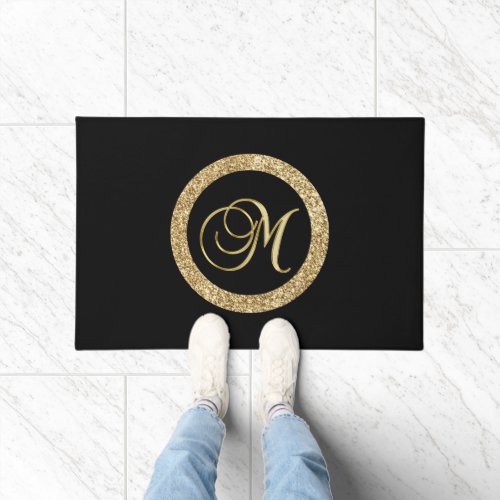 M gold monogram on black doormat