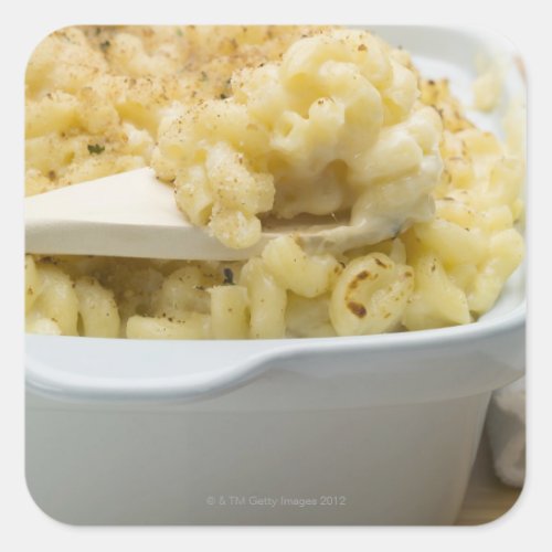 Macaroni cheese in baking dish with wooden square sticker