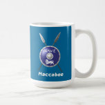 Maccabee Shield And Spears Coffee Mug<br><div class="desc">A depiction of a Maccabee's shield and two spears. The shield is adorned by a lion and text reading "Yisrael" (Israel) in the Paleo-Hebrew alphabet. English text reading "Maccabee" also appears. Add your own additional text on the reverse side. The Maccabees were Jewish rebels who freed Judea from the yoke...</div>