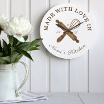 Made With Love In Nana's Kitchen Whisk Bakery Large Clock<br><div class="desc">Simple, clean, and minimal style bakery clock design featuring "made with love in Nana's Kitchen. Faux natural woodgrain bakers rolling pin and whisk design are crossing each other and placed in the center of the clock. Customize with monogram initials. Perfect gift for your nana or grandma. All artwork by Moodthology....</div>