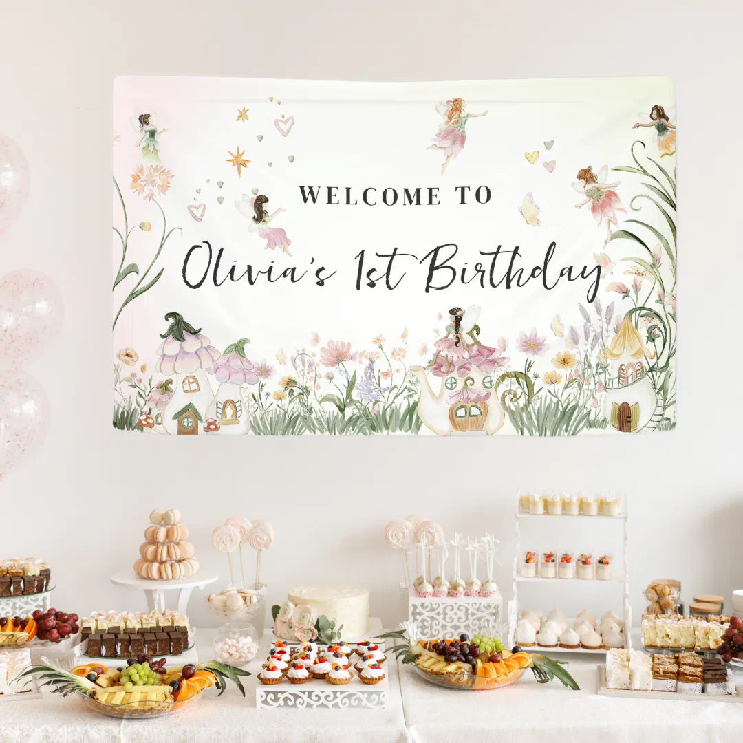 A Floral Fairy Birthday Welcome Banner placed over a cute dessert table full of colorful treats.