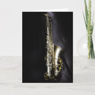 Magnificent brass saxophone on black background card