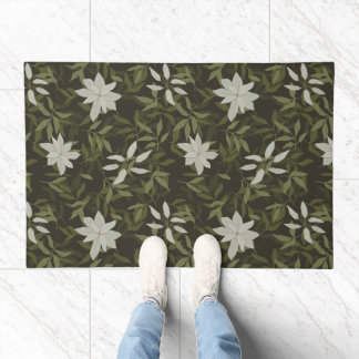 Magnolia and green leaves on black doormat