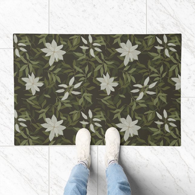 Magnolia and green leaves on black doormat (Indoor)