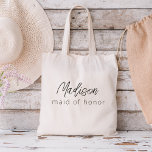 Maid of Honor Modern Minimalist Script Tote Bag<br><div class="desc">Elevate your bachelorette party with our "Bridesmaid Modern Minimalist Script" collection. This exquisite line of products embodies contemporary elegance and timeless style, perfect for celebrating your upcoming nuptials in a modern and sophisticated way. Our minimalist script design places your bridesmaids at the forefront, adding a touch of class to every...</div>