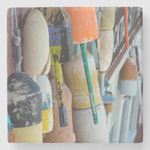Maine, Bar Harbor. Colorful lobster trap buoys Stone Coaster