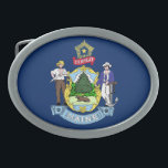 MAINE STATE FLAG BELT BUCKLE<br><div class="desc">The flag of the state of Maine features Maine's state coat of arms on a blue field. In the center of the shield, a moose rests under a tall pine tree. A farmer and seaman represent the traditional reliance on agriculture and the sea by the state. The North Star represents...</div>