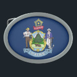 MAINE STATE FLAG BELT BUCKLE<br><div class="desc">The flag of the state of Maine features Maine's state coat of arms on a blue field. In the center of the shield, a moose rests under a tall pine tree. A farmer and seaman represent the traditional reliance on agriculture and the sea by the state. The North Star represents...</div>