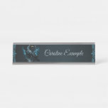 Majestic black raven sitting on an ornate,  desk name plate