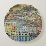 Malcesine on Lake Garda By Gustav Klimt Round Pillow<br><div class="desc">Malcesine on Lake Garda (1913) by Gustav Klimt is a vintage Victorian Era Art Nouveau fine art symbolism painting. A beautiful view of the Italian city of Malcesine with buildings and houses on the edge of the harbor. The homes and boats cast a reflection in the calm water. You can...</div>