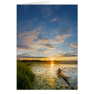 Male kayaker paddling sea kayak on still water cards