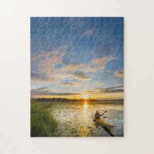 Male kayaker paddling sea kayak on still water jigsaw puzzle