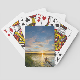 Male kayaker paddling sea kayak on still water poker cards