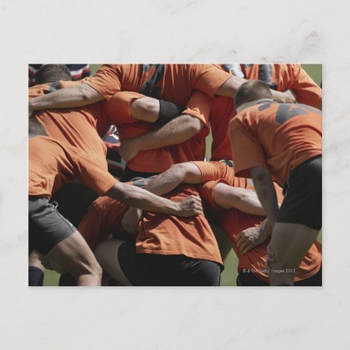 Male rugby players in scrum rear view postcard