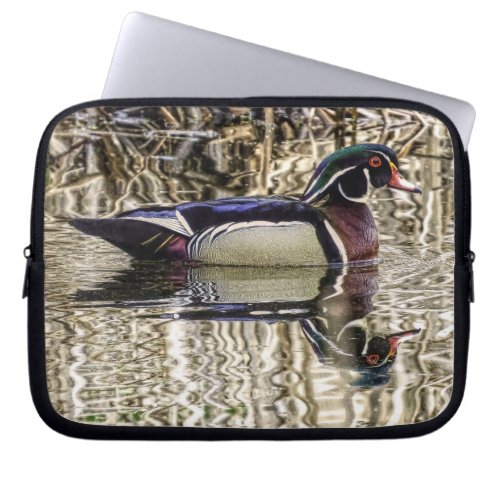 Male wood duck swimming in pond laptop sleeve