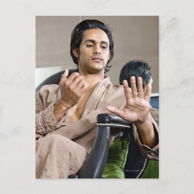 Man admiring his manicure postcard (Front)