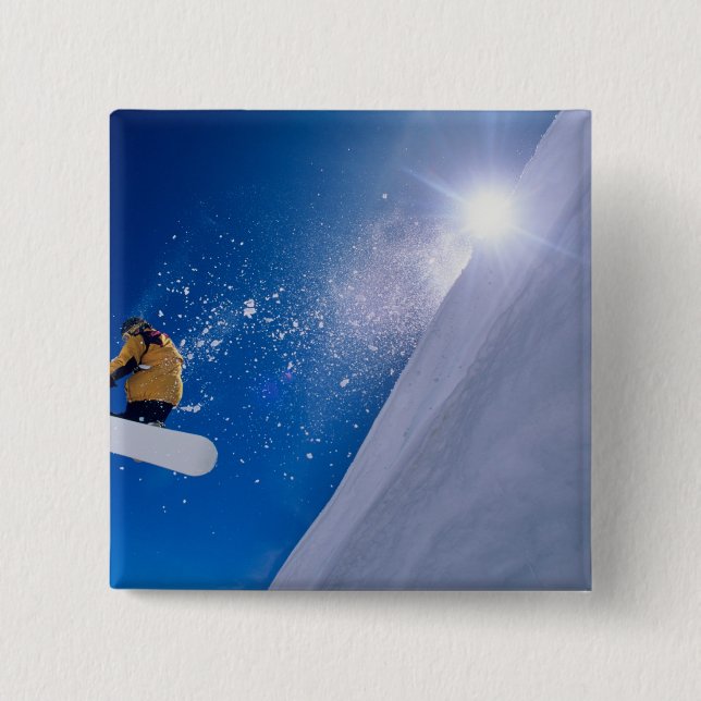 Man flying through the air on a snowboard with button (Front)