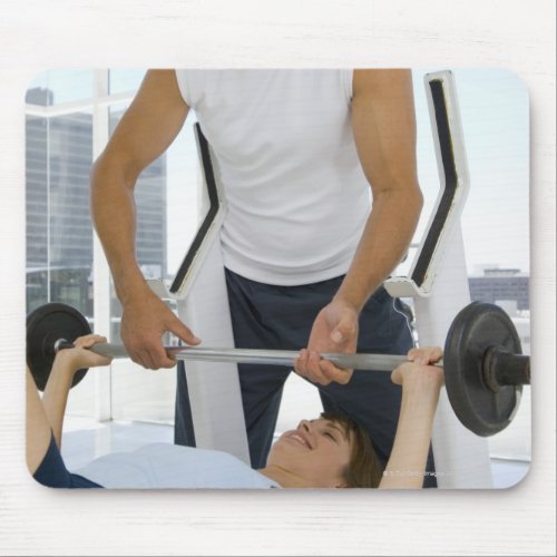 Man helping woman with weightlifting mouse pad