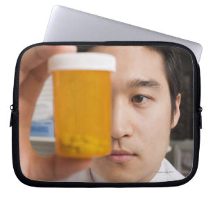 Man holding pill bottle laptop sleeve
