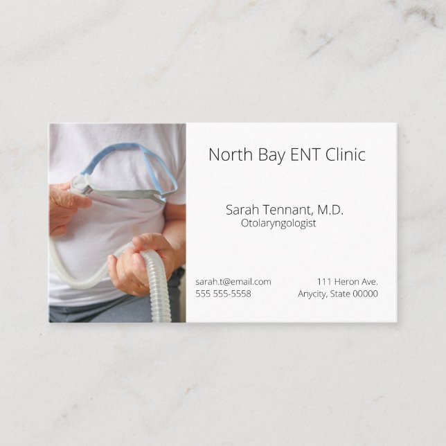 Man holds sleep apnea device business card (Front)