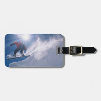 Man jumping off a large cornince on a snowboard luggage tag