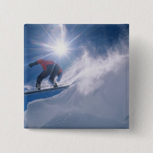 Man jumping off a large cornince on a snowboard pinback button (Front)