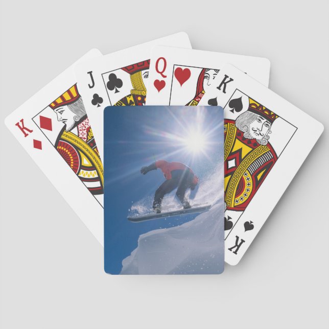 Man jumping off a large cornince on a snowboard poker cards (Back)